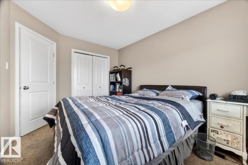 Carpeted bedroom with neutral wall tones and a white ceiling - 18080 89 Street, Edmonton, AB - Indoor Photo Showing Bedroom