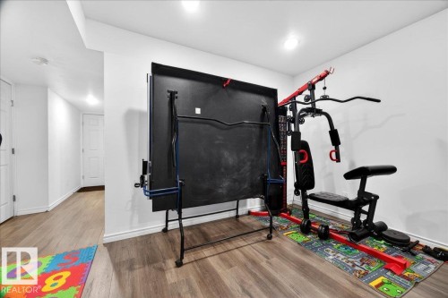Interior space featuring wood-finish flooring, recessed lighting, and white baseboards - 18080 89 Street, Edmonton, AB - Indoor
