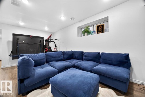 Recessed lighting illuminates this bright room featuring light wood-finish flooring - 18080 89 Street, Edmonton, AB - Indoor Photo Showing Other Room