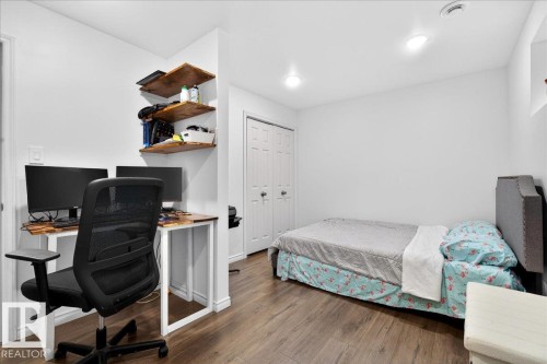 Room featuring wood-finish flooring, recessed lighting, and white walls - 18080 89 Street, Edmonton, AB - Indoor