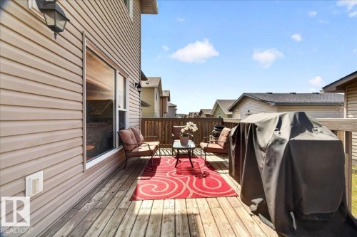 Hardwood deck featuring natural wood planks, a coordinating wood railing, and beige horizontal siding - 18080 89 Street, Edmonton, AB - Outdoor With Deck Patio Veranda With Exterior