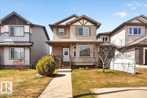 Two-story residence featuring light brown horizontal siding with decorative white and dark brown trim - 18080 89 Street, Edmonton, AB - Outdoor With Facade