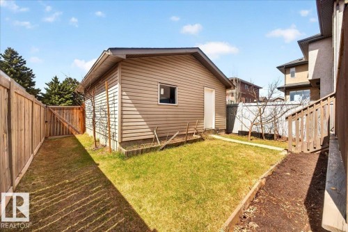 Detached garage with horizontal siding, a side entrance door, and an exterior window - 18080 89 Street, Edmonton, AB - Outdoor With Exterior