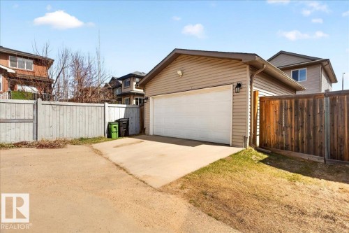 Detached garage with siding exterior and a white overhead door - 18080 89 Street, Edmonton, AB - Outdoor With Exterior