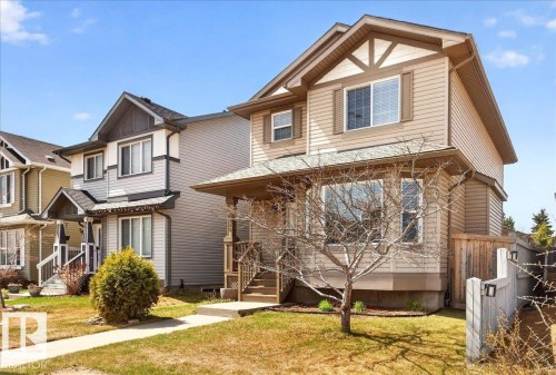 Two-story residence featuring light brown siding and a covered front porch - 18080 89 Street, Edmonton, AB - Outdoor