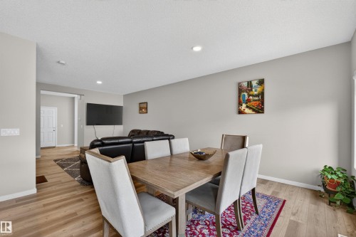 Open-concept living and dining area featuring wood-finish flooring, recessed lighting, and light gray wall tones - 22638 99A Avenue, Edmonton, AB - Indoor Photo Showing Dining Room