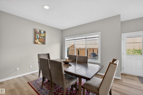 Open concept dining area featuring light-toned walls and wood-finish flooring - 22638 99A Avenue, Edmonton, AB - Indoor Photo Showing Dining Room