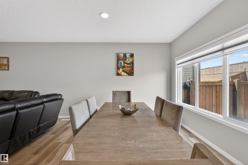 Dining area featuring wood-finish flooring, recessed lighting, and a large window with white trim - 22638 99A Avenue, Edmonton, AB - Indoor Photo Showing Dining Room