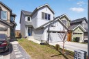 Contemporary two-story residence featuring light gray horizontal siding, a prominent front-facing gable, and a vibrant blue entry door - 22638 99A Avenue, Edmonton, AB  - Outdoor 