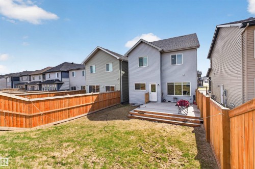 Rear exterior featuring a spacious wooden deck with steps to the yard, light gray siding, and multiple windows - 22638 99A Avenue, Edmonton, AB - Outdoor With Deck Patio Veranda With Exterior