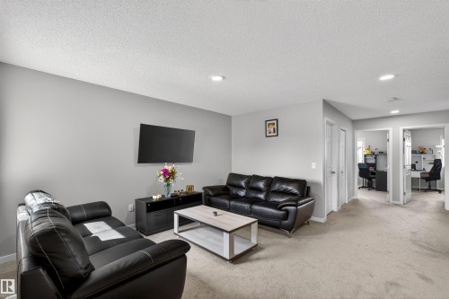 Open-concept living space featuring neutral gray walls and textured carpeting - 22638 99A Avenue, Edmonton, AB - Indoor Photo Showing Living Room