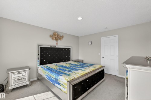 Recessed lighting illuminates neutral-toned walls and grey carpet flooring - 22638 99A Avenue, Edmonton, AB - Indoor Photo Showing Bedroom