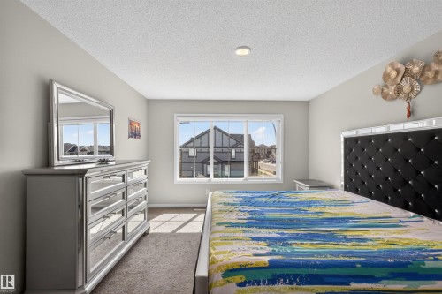 Bright bedroom featuring a large window, neutral wall paint, and recessed lighting - 22638 99A Avenue, Edmonton, AB - Indoor Photo Showing Bedroom