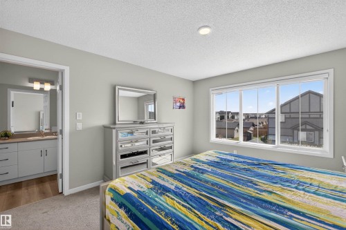 Bedroom featuring a large window, neutral wall paint, and carpeted flooring - 22638 99A Avenue, Edmonton, AB - Indoor Photo Showing Bedroom
