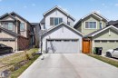Modern two-story residence featuring a light gray exterior, an attached garage with a concrete driveway, and gabled rooflines - 22638 99A Avenue, Edmonton, AB  - Outdoor With Facade 