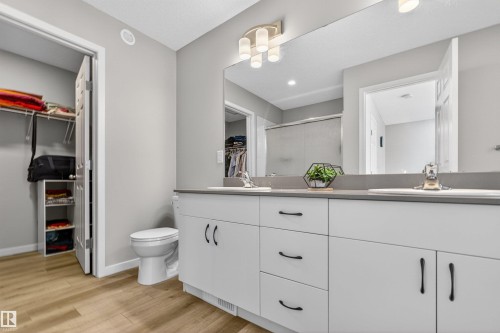 Bathroom with a double vanity featuring white cabinetry and dark hardware - 22638 99A Avenue, Edmonton, AB - Indoor Photo Showing Bathroom
