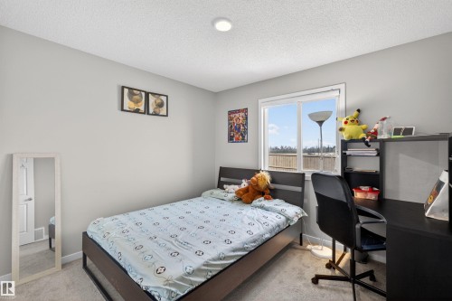 Bedroom featuring light gray walls, plush gray carpet, a white framed window, and a recessed ceiling light - 22638 99A Avenue, Edmonton, AB - Indoor Photo Showing Bedroom