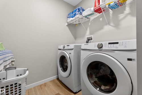 Dedicated laundry area featuring a front-loading washing machine and dryer - 22638 99A Avenue, Edmonton, AB - Indoor Photo Showing Laundry Room
