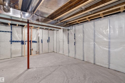 Unfinished basement with concrete flooring, exposed wood joists, and insulated perimeter walls - 22638 99A Avenue, Edmonton, AB - Indoor Photo Showing Basement