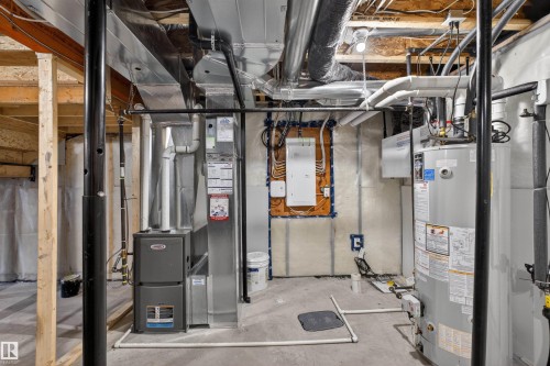 Utility space featuring a water heater, furnace, exposed ductwork, exposed electrical conduit, and concrete flooring - 22638 99A Avenue, Edmonton, AB - Indoor Photo Showing Basement