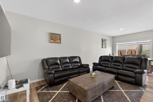 Open-concept living area featuring light gray walls, recessed lighting, and wood-finish flooring - 22638 99A Avenue, Edmonton, AB - Indoor Photo Showing Living Room