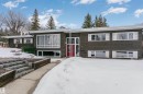 This property features a contemporary exterior with dark siding and white trim, complemented by a vibrant red front door - 24 Sable Crescent, St. Albert, AB  - Outdoor With Facade 