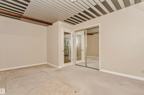 Room featuring light-colored carpet, white baseboards, and a ceiling with a patterned design - 24 Sable Crescent, St. Albert, AB -  Photo Showing Other Room