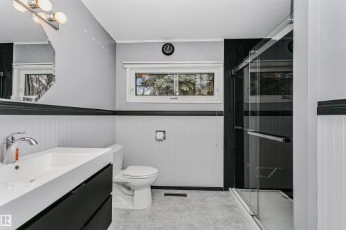 Bathroom with a contemporary vanity, a glass-enclosed shower, and a window providing natural light - 24 Sable Crescent, St. Albert, AB - Indoor Photo Showing Bathroom