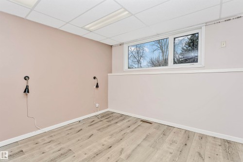 This room features light-toned flooring, a window offering views of trees, and recessed ceiling lighting - 24 Sable Crescent, St. Albert, AB - Indoor Photo Showing Other Room