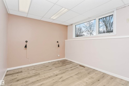 This versatile room features light-toned plank flooring, a window offering views of trees, and a ceiling with recessed lighting - 24 Sable Crescent, St. Albert, AB - Indoor Photo Showing Other Room
