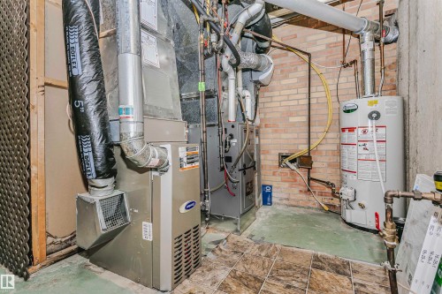 The property features a water heater and furnace, with visible ductwork and piping - 24 Sable Crescent, St. Albert, AB - Indoor Photo Showing Basement
