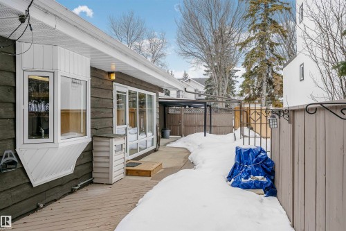 The property features a wooden deck alongside the exterior, which includes a bay window and large glass doors - 24 Sable Crescent, St. Albert, AB - Outdoor With Exterior