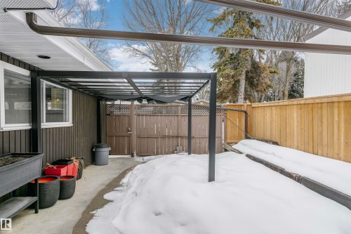 The property features a patio area with a black metal pergola, providing an outdoor living space - 24 Sable Crescent, St. Albert, AB - Outdoor With Exterior