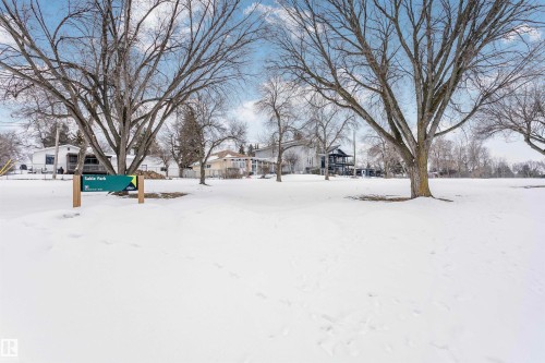 View of the surrounding neighborhood area featuring a snow-covered field with bare trees and distant homes - 24 Sable Crescent, St. Albert, AB - Outdoor