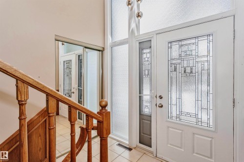 Entryway featuring a white door with decorative glass inserts, a large frosted glass sidelight, and a tiled floor - 24 Sable Crescent, St. Albert, AB - Indoor Photo Showing Other Room