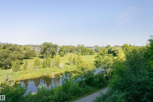 Expansive green spaces and mature trees surround a serene body of water, offering a peaceful setting - 24 Sable Crescent, St. Albert, AB - Outdoor With View