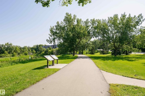 aThe property is located within a community featuring a paved walking path, lush green grass, and mature trees - 24 Sable Crescent, St. Albert, AB - Outdoor With View