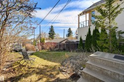 Expansive backyard featuring a partial lawn, mature trees, and privacy fencing - 