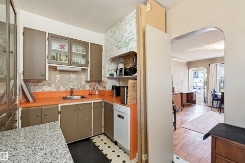 Kitchen featuring painted cabinetry, a stainless steel sink, and a white dishwasher - 9816 93 Avenue, Edmonton, AB - Indoor Photo Showing Kitchen