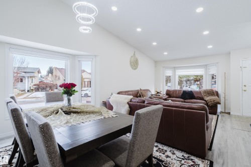 Dining area with a large bay window, recessed lighting, and a contemporary chandelier - 236 Lago Lindo Crescent, Edmonton, AB - Indoor