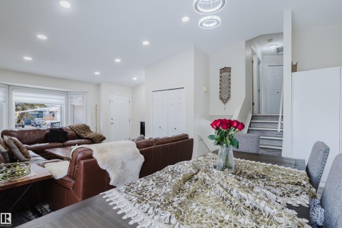 Open-concept living space featuring recessed lighting, a bay window, and a contemporary staircase with wood-finish treads - 236 Lago Lindo Crescent, Edmonton, AB - Indoor