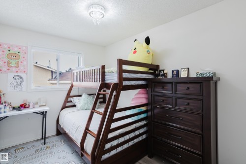 Room featuring a ceiling-mounted light fixture, white walls, and a window with white framing - 236 Lago Lindo Crescent, Edmonton, AB - Indoor Photo Showing Bedroom
