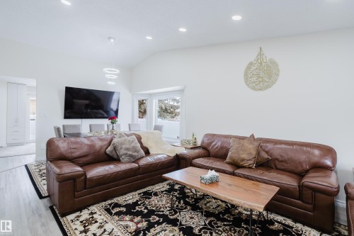 Open-concept living area featuring vaulted ceilings, recessed lighting, and light wood-finish flooring - 236 Lago Lindo Crescent, Edmonton, AB - Indoor Photo Showing Living Room