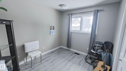 Room with light gray walls and wood-finish flooring - 3311 108 Street, Edmonton, AB - Indoor