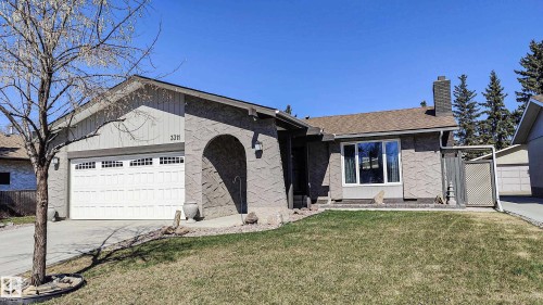 Ranch-style exterior with a two-car garage, arched entry, and a prominent chimney - 3311 108 Street, Edmonton, AB - Outdoor
