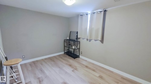 Room featuring wood-finish flooring, neutral wall paint, and white trim - 3311 108 Street, Edmonton, AB - Indoor Photo Showing Other Room