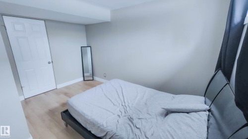 Room featuring light wood-finish flooring, white baseboards, and neutral-toned walls - 3311 108 Street, Edmonton, AB - Indoor Photo Showing Bedroom