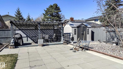 Spacious patio area with concrete pavers, a privacy fence, and mature trees - 3311 108 Street, Edmonton, AB - Outdoor