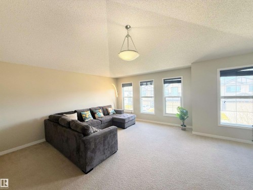 Spacious living area featuring neutral carpeting and paint tones - 3538 Claxton Crescent, Edmonton, AB - Indoor