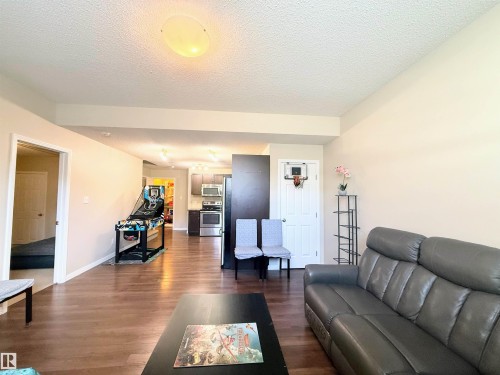 Open-concept living space featuring wood-finish flooring and neutral wall tones - 3538 Claxton Crescent, Edmonton, AB - Indoor Photo Showing Living Room